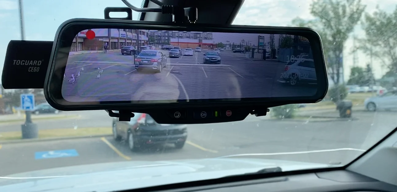 Rear view mirror dash cam footage showing close call